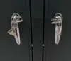 Close-up of two metal handles with keys on a dark gray surface. Náhľad obrázku produktu