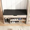 A shoe cabinet with a padded seat on top, filled with various shoes on its shelves. Podgląd zdjęcia produktu