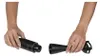 Two hands are shown assembling or disassembling a black immersion blender. Produktbild-Vorschau