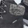 A close-up view of a black boot with a knitted cuff. Anteprima dell’immagine prodotto