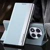 A light blue flip case for a smartphone is shown standing upright, with the phone's camera module visible. Produktbild-Vorschau