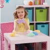 A young girl is playing with colorful Playfoam shapes at a pink table. Produktbild-Vorschau