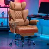 A gaming chair is shown in a room with colorful lighting, a computer monitor, and gaming accessories. Náhled obrázku produktu
