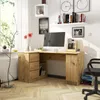 A home office setup with a corner desk, computer, and decorative items. Produktbild-Vorschau