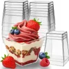 A stack of clear plastic dessert cups, with one cup filled with a layered dessert and topped with soft-serve ice cream, berries, and granola. Podgląd zdjęcia produktu