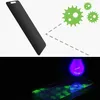 The top part of the image shows a black screen protector with cartoon germs, implying it has antimicrobial properties. The bottom part shows a screen protector under a UV light, revealing fingerprints. Anteprima dell’immagine prodotto