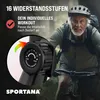An older man riding a stationary bike outdoors, with a close-up of the resistance control dial. Produktbild-Vorschau