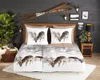 A bedroom scene with a bed dressed in a duvet cover featuring a winter landscape with deer. Decorative elements like skis and deer antlers are on the wall. Anteprima dell’immagine prodotto