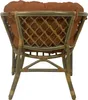 The back view of a rattan armchair with a brown cushion. Produktbild-Vorschau