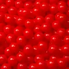 A close-up, overhead view of a large pile of small, red, spherical balls. Produktbild-Vorschau