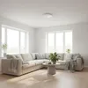 A bright and airy living room with a large sectional sofa, coffee table, and windows. Náhľad obrázku produktu