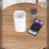 A white aroma diffuser and a smartphone are placed on a wooden table next to a small potted plant. Produktbild-Vorschau