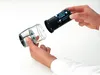 Hands assembling an electric pepper grinder. Anteprima dell’immagine prodotto
