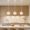 A modern kitchen interior with three pendant lights hanging above a countertop with a sink and lemons. Náhled obrázku produktu
