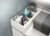 A close-up view of a white storage unit with various bathroom items and folded towels. Produktbild-Vorschau