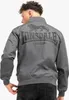 A man is wearing a gray Lonsdale bomber jacket with a black logo on the back. Anteprima dell’immagine prodotto