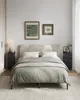 A bedroom scene with a bed, nightstands, and artwork. Náhled obrázku produktu