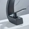 Close-up of a black faucet on a white sink. Podgląd zdjęcia produktu