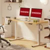 A modern home office setup with a standing desk, computers, and accessories. Voir les images du produit
