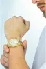 A man's wrist wearing a gold watch. Anteprima dell’immagine prodotto