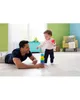 A father and child are playing with stacking rings on the floor. Produktbild-Vorschau