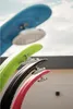 A close-up view of several outdoor shower heads in different colors. Produktbild-Vorschau