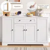 A white sideboard cabinet is shown in a room setting, with decorative items on top and informational callouts. Náhľad obrázku produktu