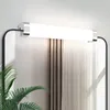 A modern bathroom vanity light fixture mounted above a mirror, with sheer curtains in the background. Anteprima dell’immagine prodotto