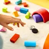 A hand reaching for keys with colorful building blocks scattered around. Produktbild-Vorschau