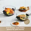 Two glass cooking dishes with food, placed on a kitchen counter. Produktbild-Vorschau