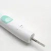 A close-up shot of the handle of a white electric toothbrush. Produktbild-Vorschau