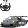 A remote-controlled Porsche 911 GT2 RS Clubsport 25 car and its steering wheel remote control. Podgląd zdjęcia produktu