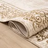 A close-up of a rolled-up rug with a vintage oriental pattern, showing the texture and edge detail. Produktbild-Vorschau