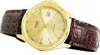 A close-up, angled shot of a gold-faced Casio watch with a brown, crocodile-patterned leather strap against a white background. Voir les images du produit