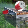 A close-up shot of a red electric grill motor attached to a rotisserie spit over a barbecue grill filled with meat. Produktbild-Vorschau