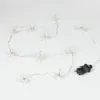 A string of white snowflake-shaped lights with a black power plug on a white background. Produktbild-Vorschau