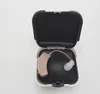 A hearing aid is placed inside its open case. Podgląd zdjęcia produktu