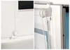 Close-up of a white roller blind mechanism attached to a window frame. Produktbild-Vorschau