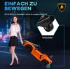 A woman is walking with a toy Lamborghini car, which is being pulled by its handle. The car is orange and black, and the background shows a blurred city street at night. Produktbild-Vorschau