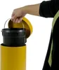 A hand is shown lifting the inner bin out of a yellow trash can. Podgląd zdjęcia produktu