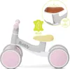 A light gray balance bike with pink wheels and a yellow seat, shown against a white background. Inset diagrams highlight the seat and eco-friendly material. Náhľad obrázku produktu