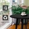 A black outdoor side table with a cup of coffee on it, placed near a window with plants. Produktbild-Vorschau