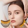 A woman's face with a grid overlay, and a makeup brush in the foreground. Anteprima dell’immagine prodotto