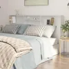A bedroom scene with a bed and a headboard with shelves. Náhľad obrázku produktu