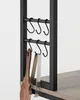 Close-up of kitchen utensils hanging on hooks attached to a shelf. Náhled obrázku produktu