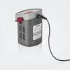 A grey battery pack with a red button and a black charging cable plugged in, set against a white and light grey gradient background. Produktbild-Vorschau