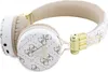 A pair of white and beige GUESS wireless headphones with gold accents, displayed against a white background. Voir les images du produit