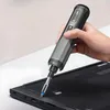 A hand is using a cordless screwdriver to work on a laptop. Voir les images du produit