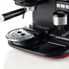 A close-up view of the lower section of a black and red espresso machine, showing the drip tray and portafilter holder. Produktbild-Vorschau
