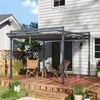 A backyard deck with a pergola, chairs, and plants. Produktbild-Vorschau